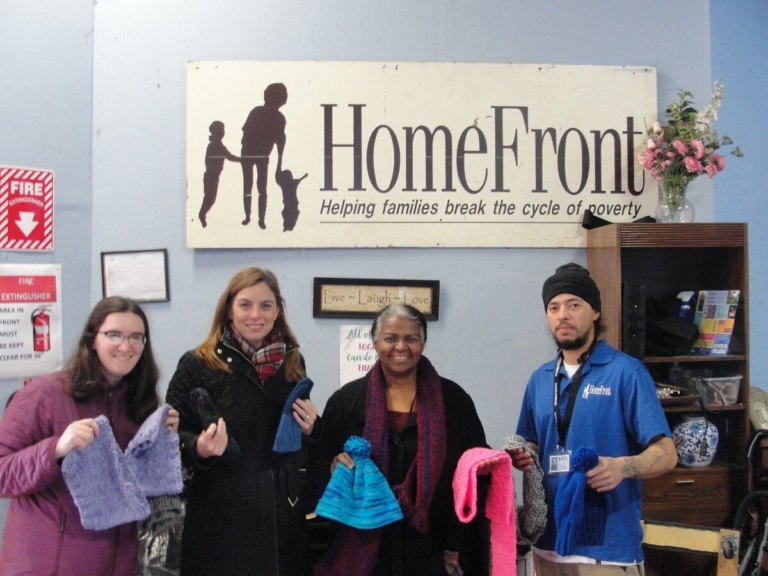 Lawrence Library knitting circle members donate items to HomeFront