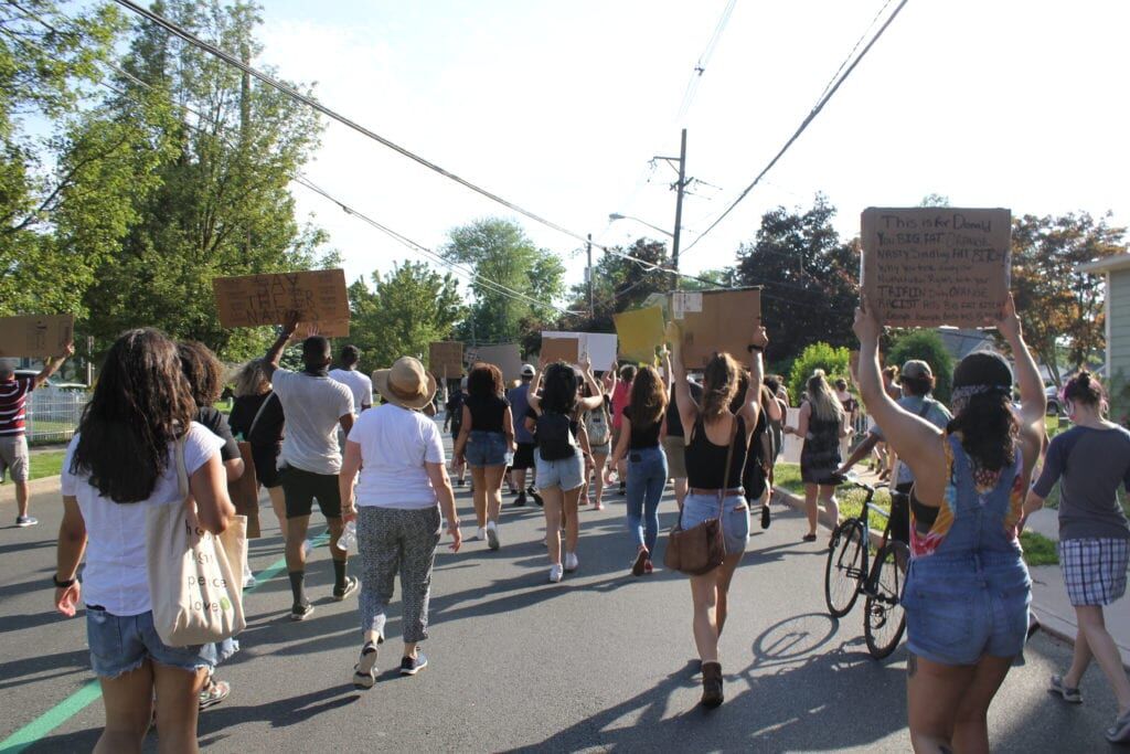 Protesters march down Route 33 at Hamilton Township rally