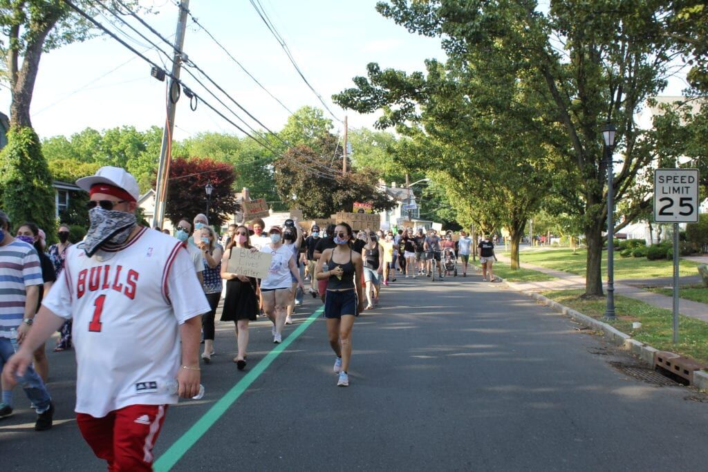 Protesters march down Route 33 at Hamilton Township rally