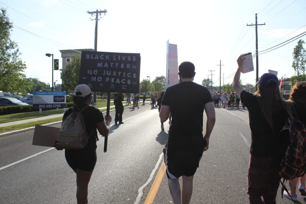 Protesters march down Route 33 at Hamilton Township rally
