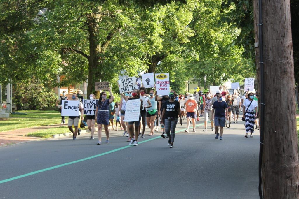 Protesters march down Route 33 at Hamilton Township rally