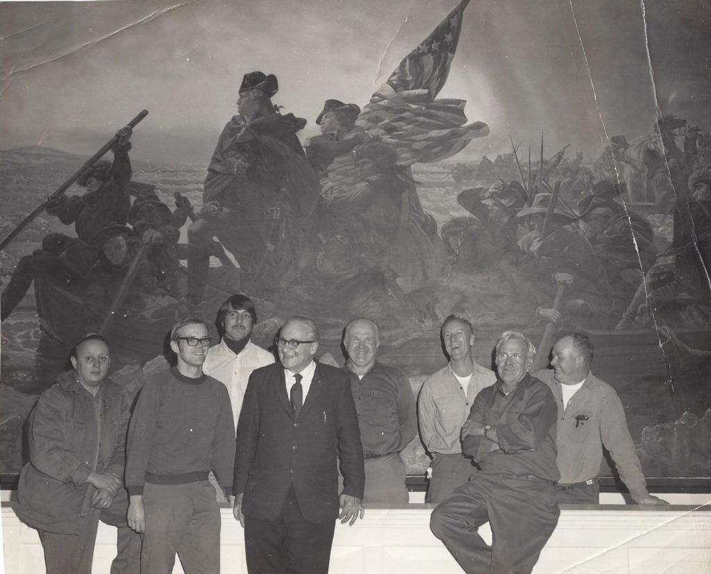 Bill Cooper (far right) and other park staff pose in front of the Leutze painting in the park Visitor Center. Photo courtesy of Barbara Felver.jpg