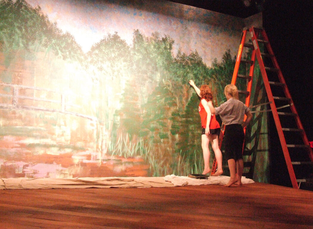 Summer 2008 Artistic Director and scenic artist Heather May '10 at work on the backdrop.JPG