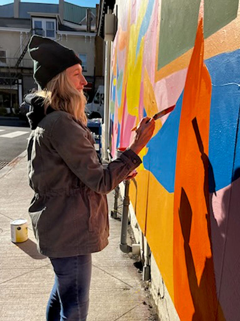 Jessica Durrie helping to paint the sponsored mural.JPG